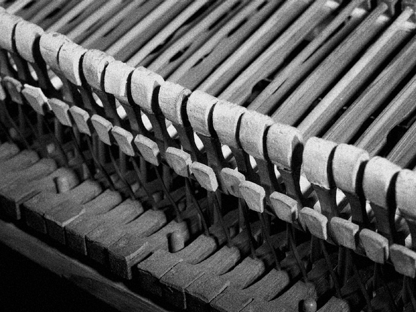 Close of photo of exposed piano hammers